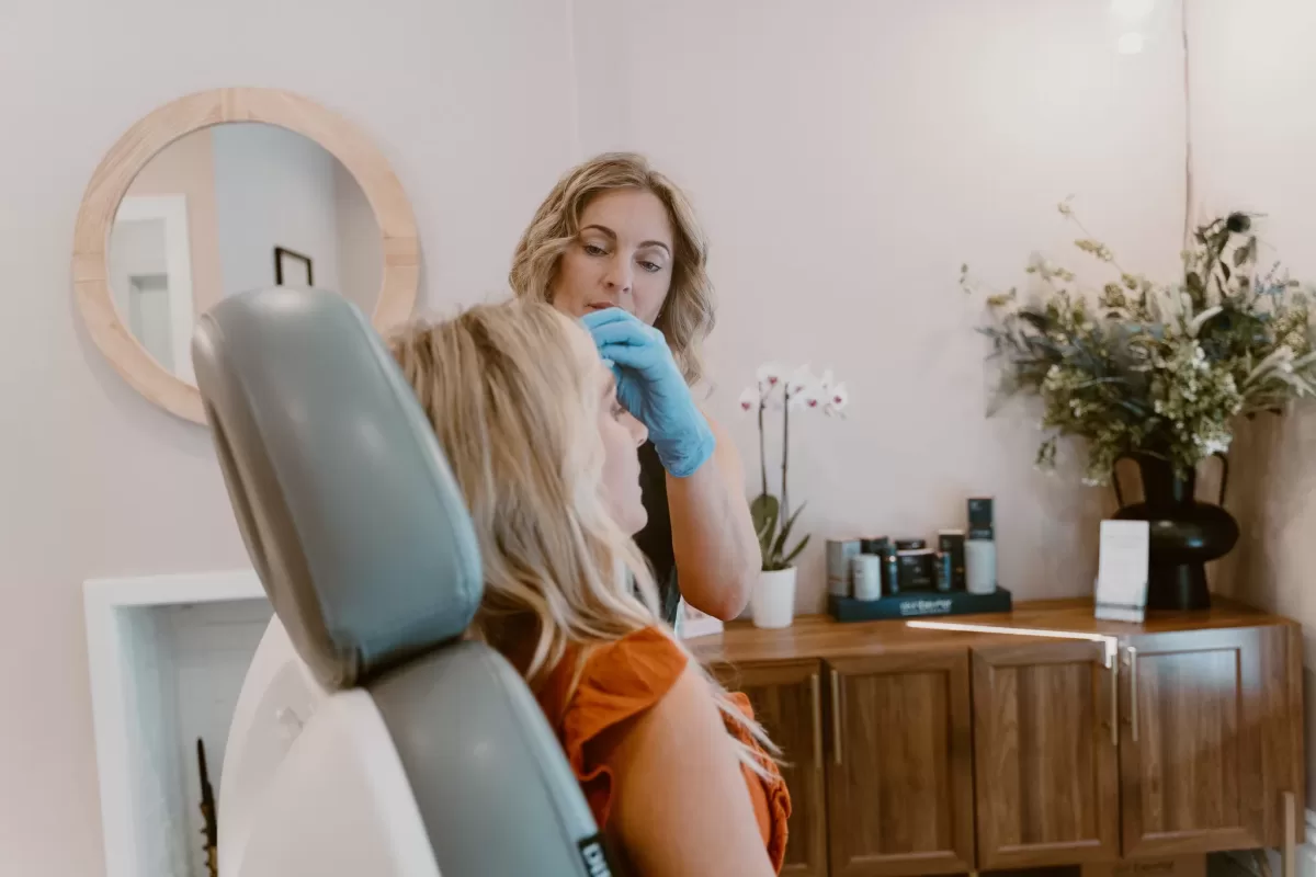 female receiving acne treatment on forehead