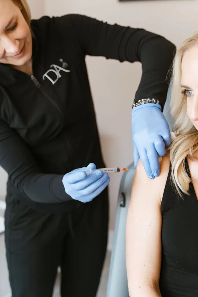 Patient receiving vitamin B-12 Injection on shoulder