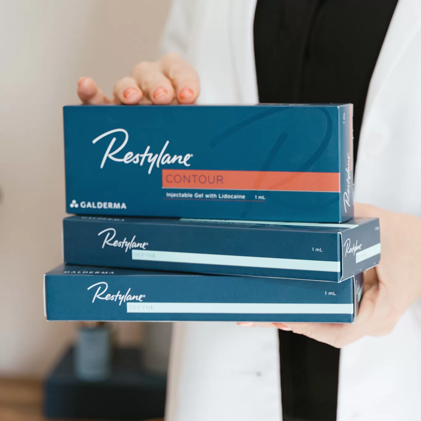 close up of person holding packages of Restylane