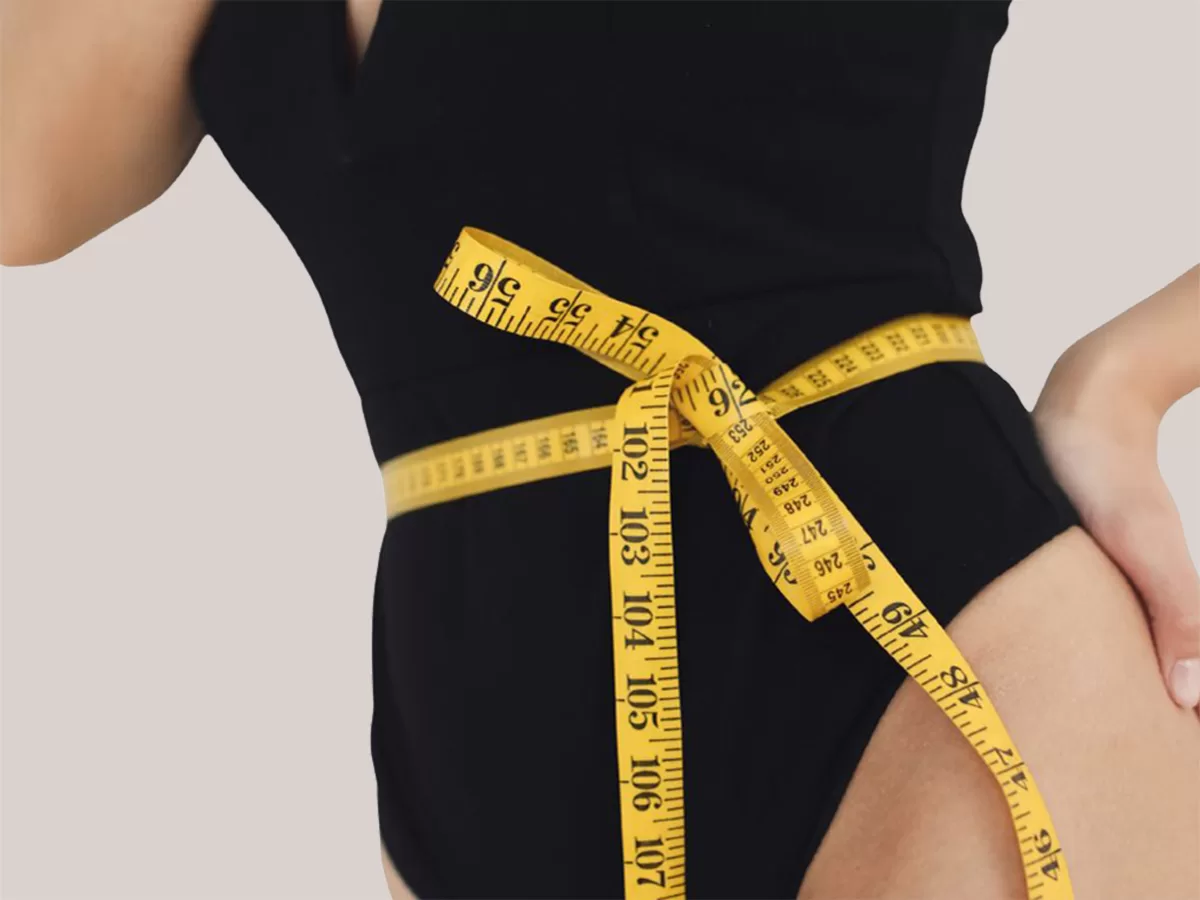 Female with measuring tape around waistline